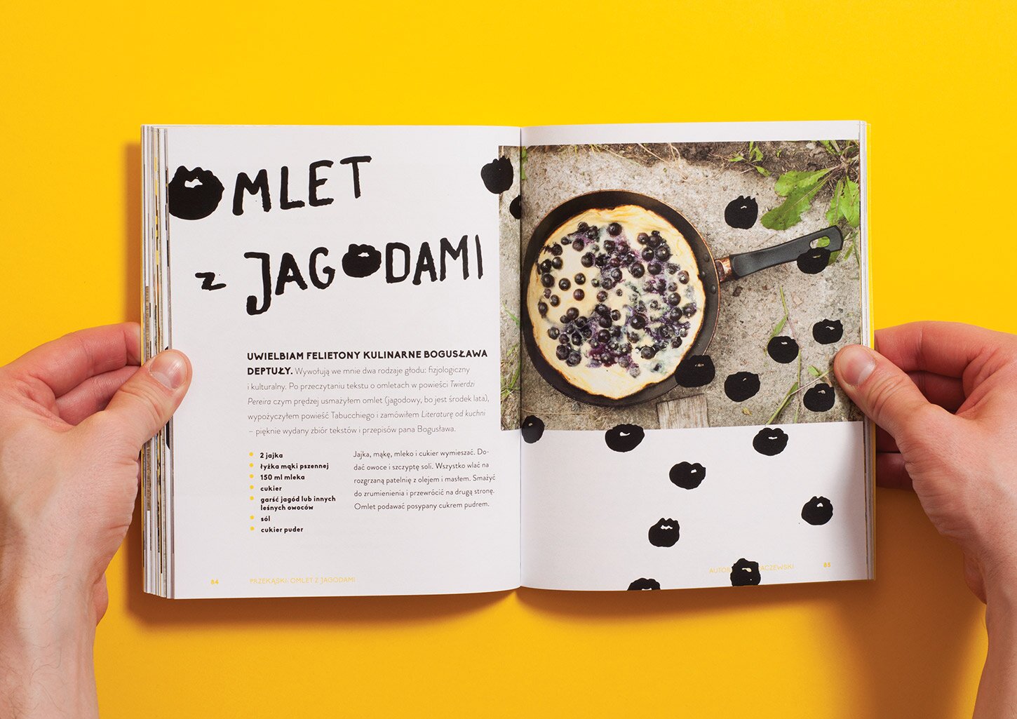 UCZTA cookbook's spread with a picture of an omelette with blueberries
